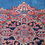 Persian Heriz rug central medallion detail with red, cream, and blue interlocking shapes