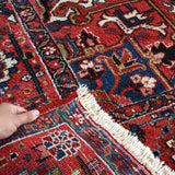 Heriz rug edge with cream fringe, red and blue mosaic pattern, close-up
