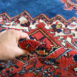 Heriz rug tassel fringe edge, red and blue central medallion pattern