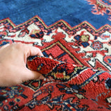 Heriz rug tassel fringe edge, red and blue central medallion pattern