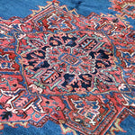 Persian Heriz rug fabric detail: blue ground with red and cream geometric motifs