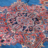 Persian Heriz rug fabric detail: blue ground with red and cream geometric motifs