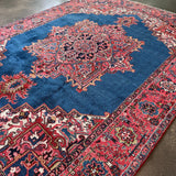 Heriz rug large rectangular design with blue center medallion and red border