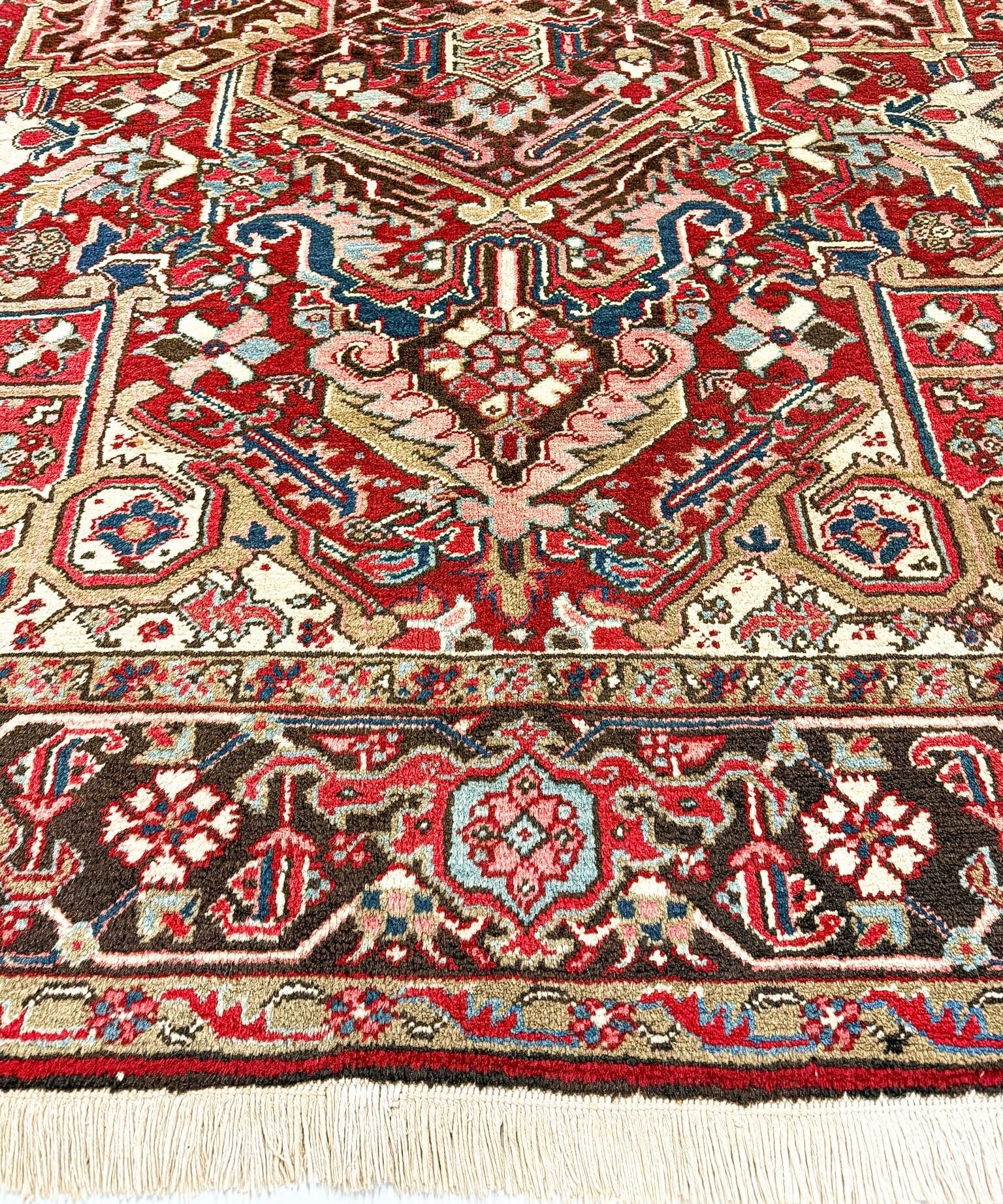 Heriz rug center medallion close-up with red, blue, cream, and gold geometric designs
