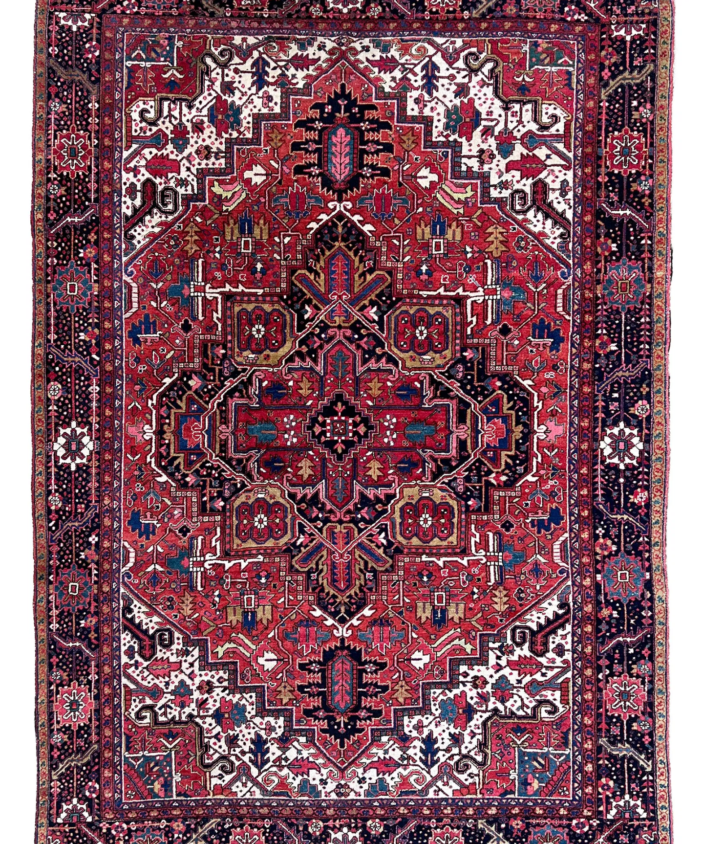 Persian Heriz rug with central crimson medallion, navy accents, and ornate border