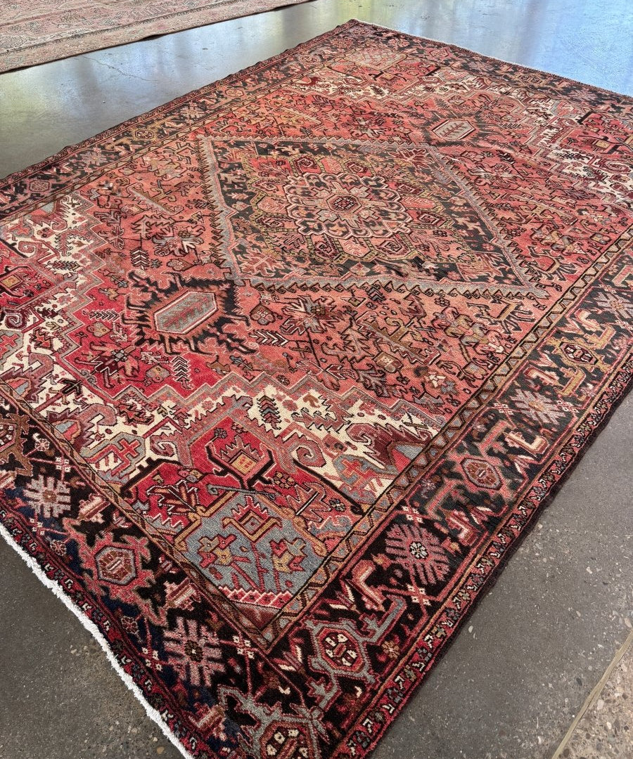 Persian Heriz rug in rust red with dark navy and cream diamond patterns