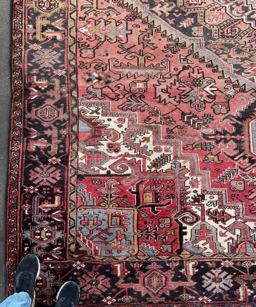 Persian Heriz rug with red and dark navy geometric medallion border