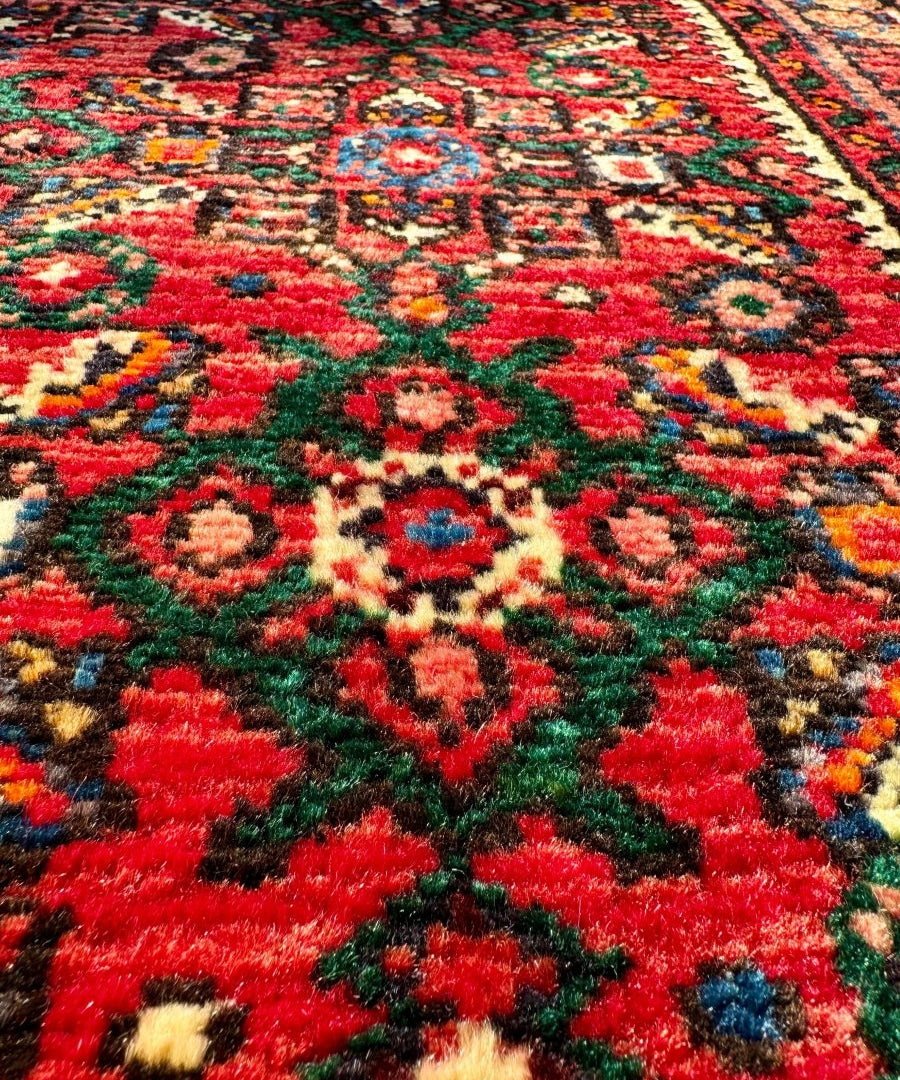 Hossein Abad Persian runner rug close-up of red floral medallions with green accents