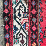 Persian runner rug, red floral and geometric border detail with cream accents