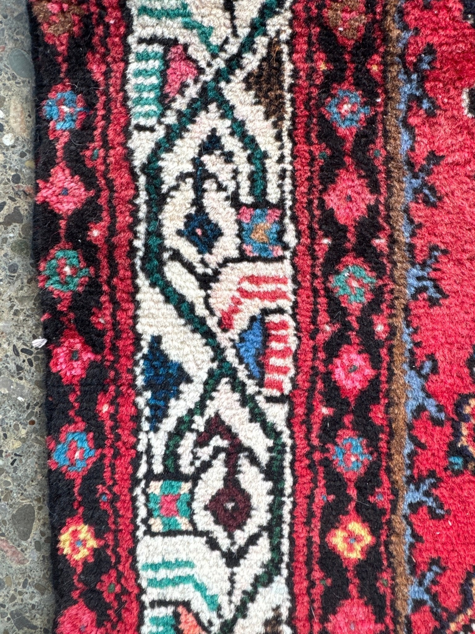 Persian runner rug, red floral and geometric border detail with cream accents