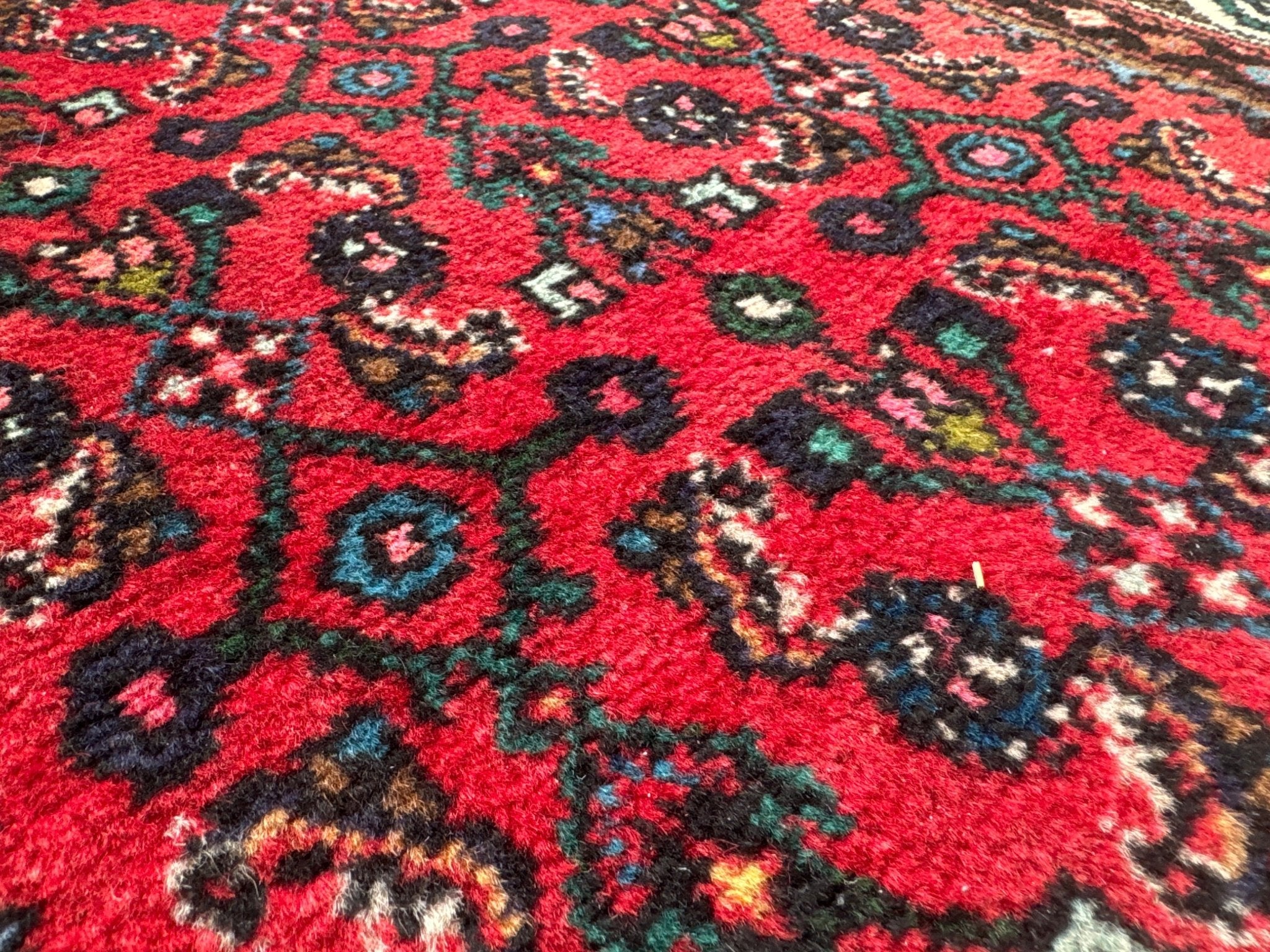Persian runner rug, red field with black and teal medallion motifs