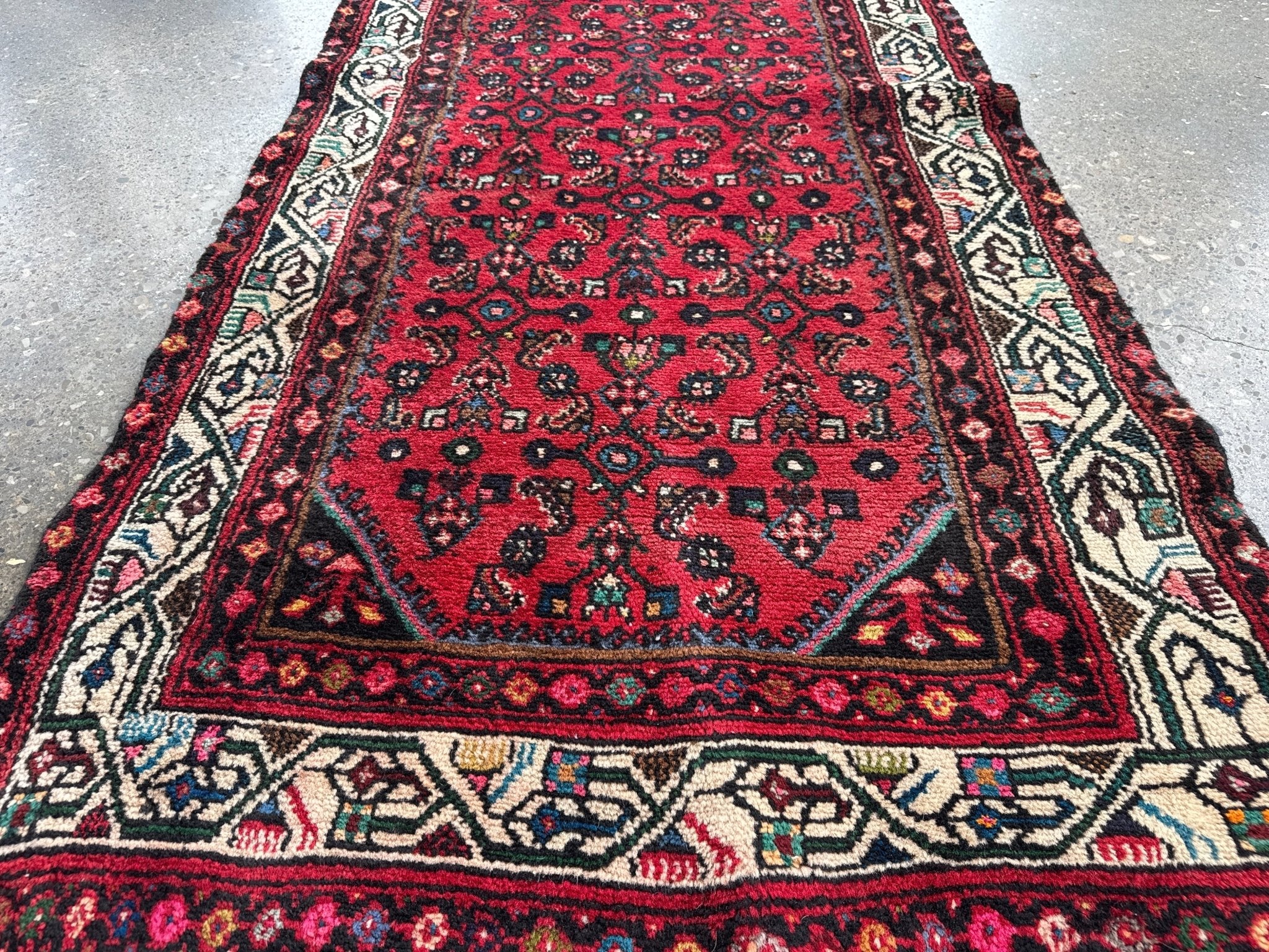 Red runner rug center panel with intricate geometric medallions and border stripe.
