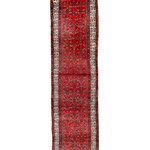 Red Persian-style runner rug with medallion motif and cream geometric border.