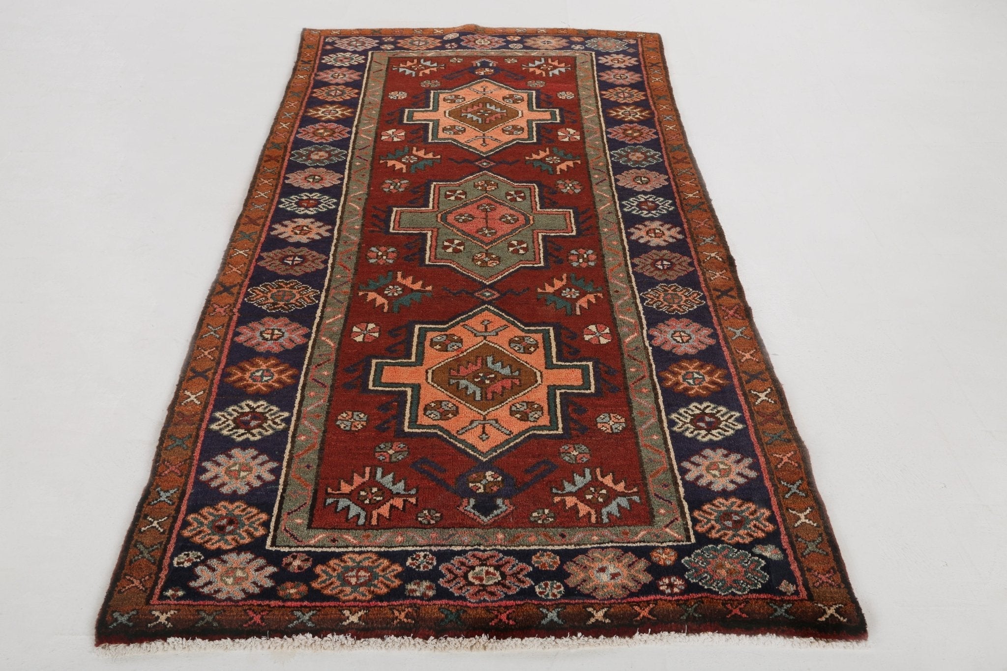 Persian Jozan rug with rust-red center medallions and navy side borders