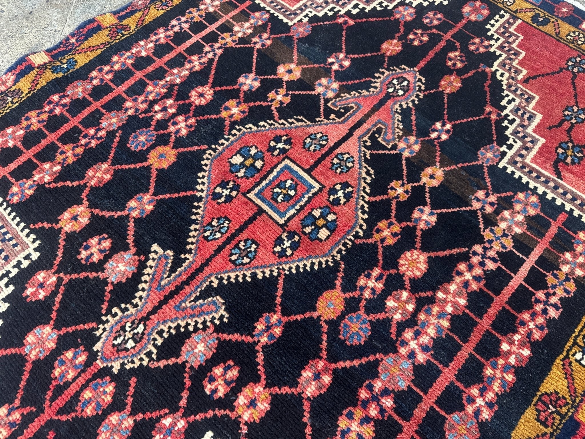 Persian Jozan rug with navy field and red geometric medallion pattern