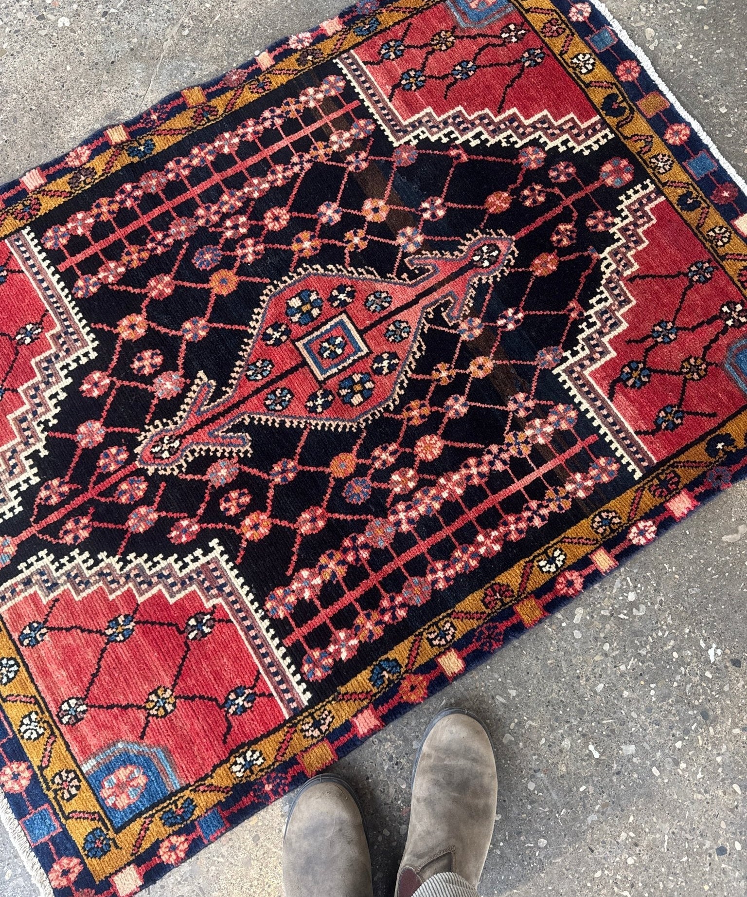 Persian Jozan rug with red center panel, navy background, and blue medallion accents