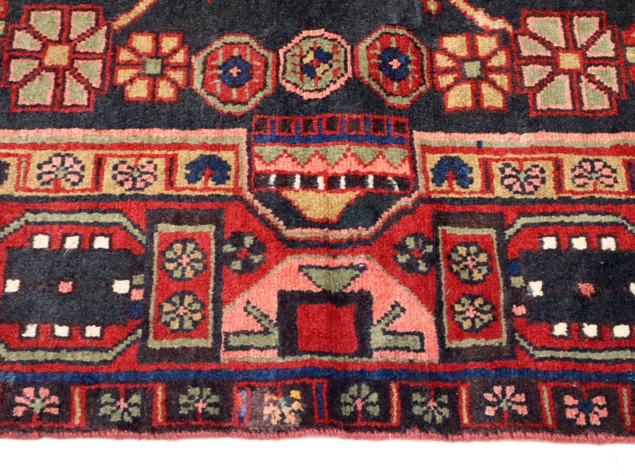 Persian Hamadan rug border detail with red geometric motifs and blue corner forms