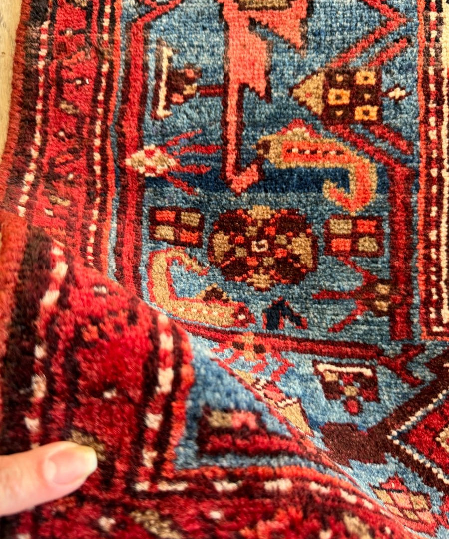 Persian Jozan rug close-up of red ground with blue ornament and cream details