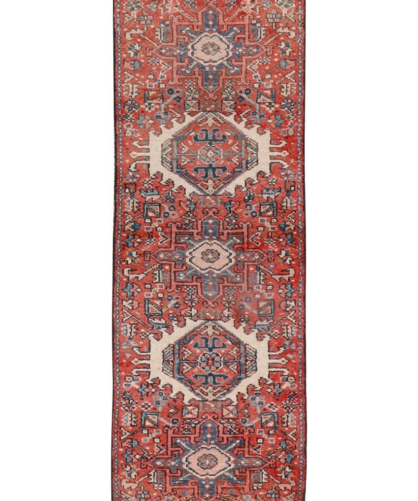 Persian-style runner rug with terracotta, navy, and cream geometric medallions