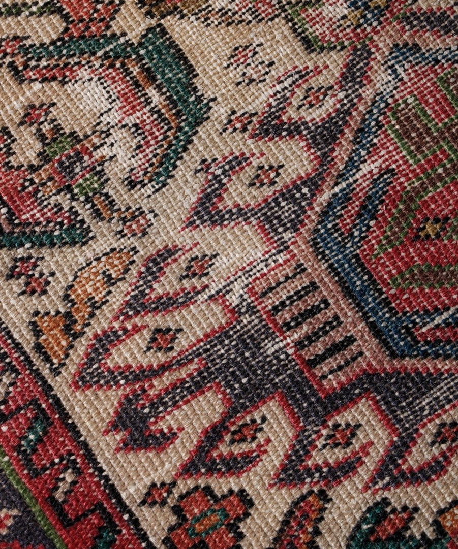 Persian runner rug with cream background and multicolor geometric medallion pattern