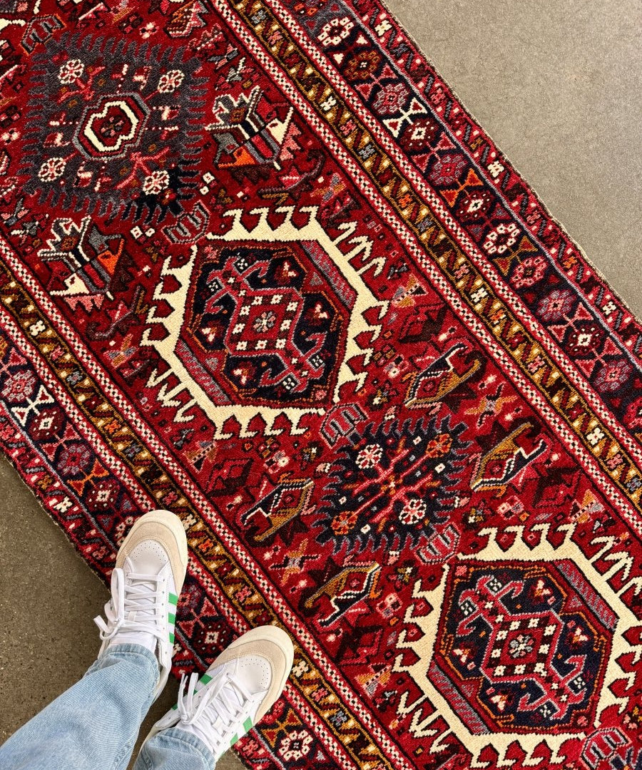 Persian style runner rug, red field with cream and navy patterns, long diagonal border