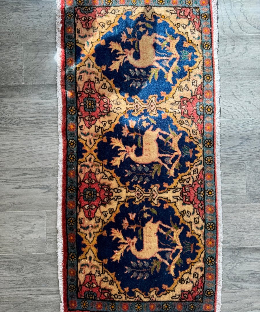 Persian Kashan rug with navy blue medallions, multicolor border, and frayed edge