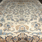 Persian Kashan rug with ivory field and blue floral medallion; ornate scrolling border