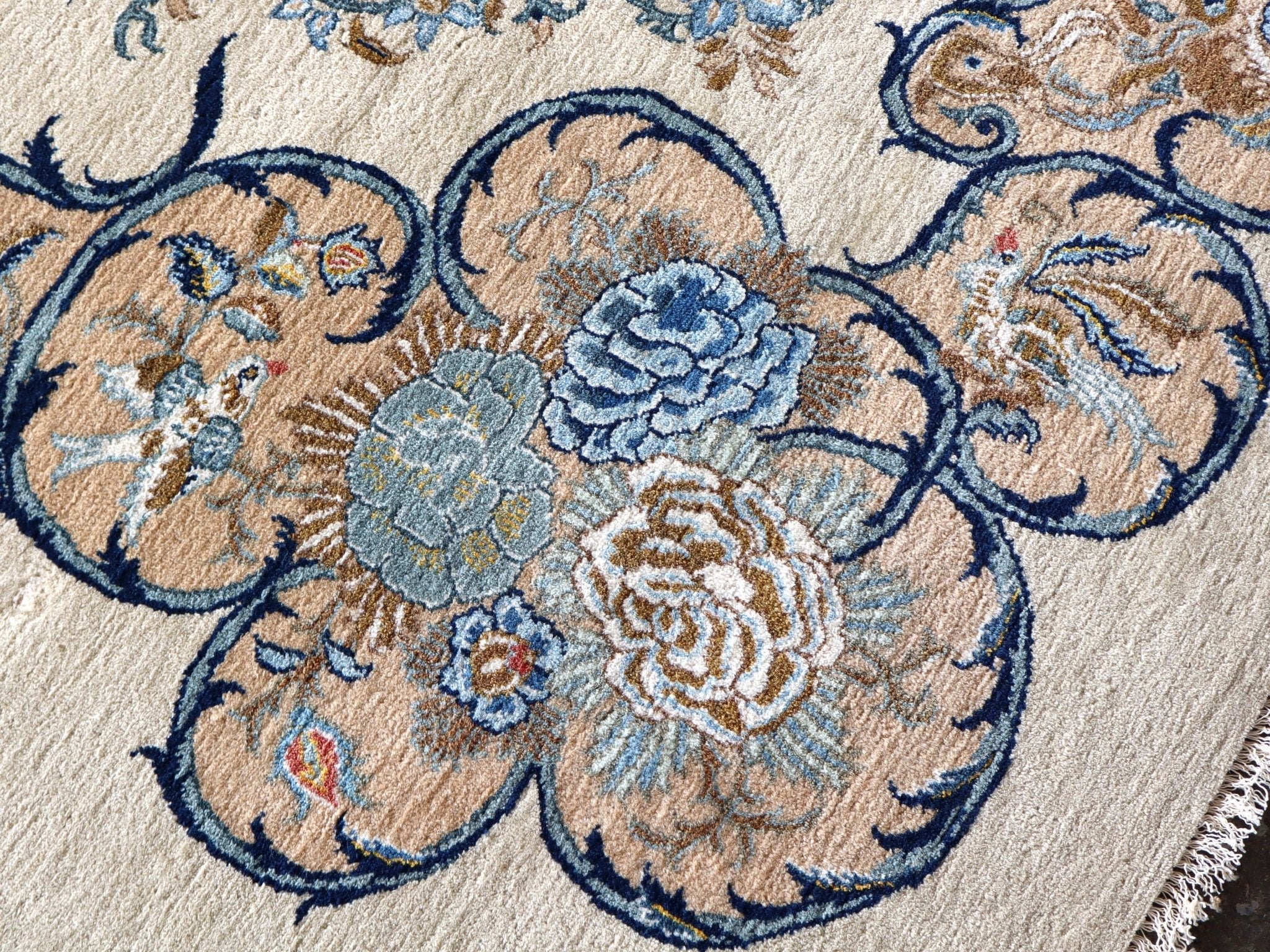 Persian Kashan rug floral vine pattern in cream, navy, and light blue close-up