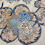 Persian Kashan rug floral vine pattern in cream, navy, and light blue close-up