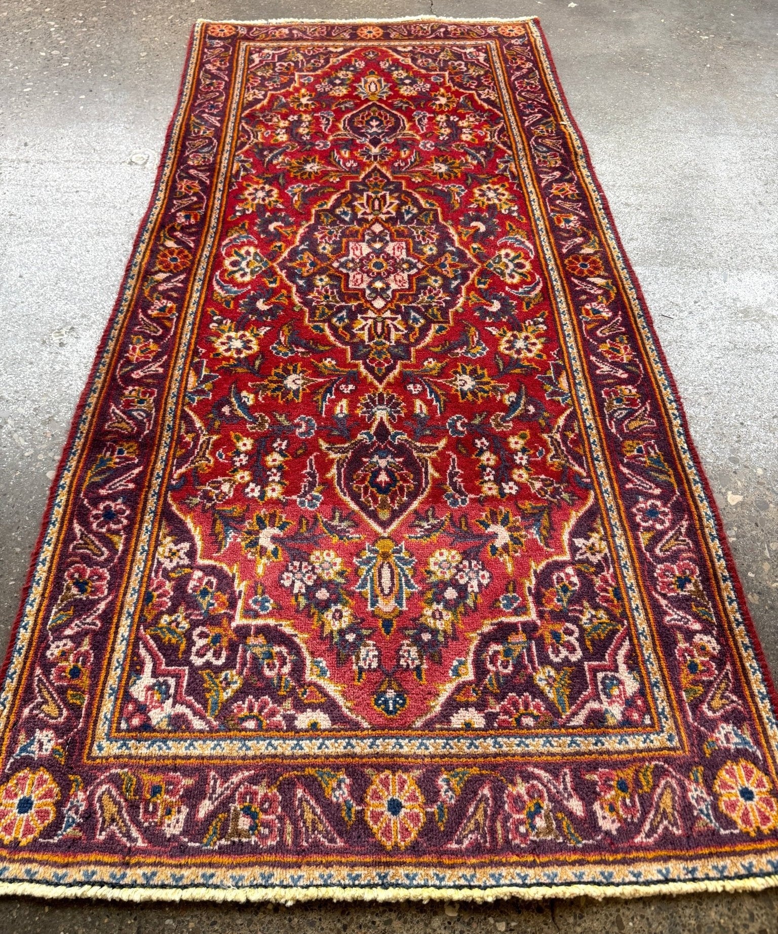 Persian Kashan runner rug with red center medallion and navy ornamental border