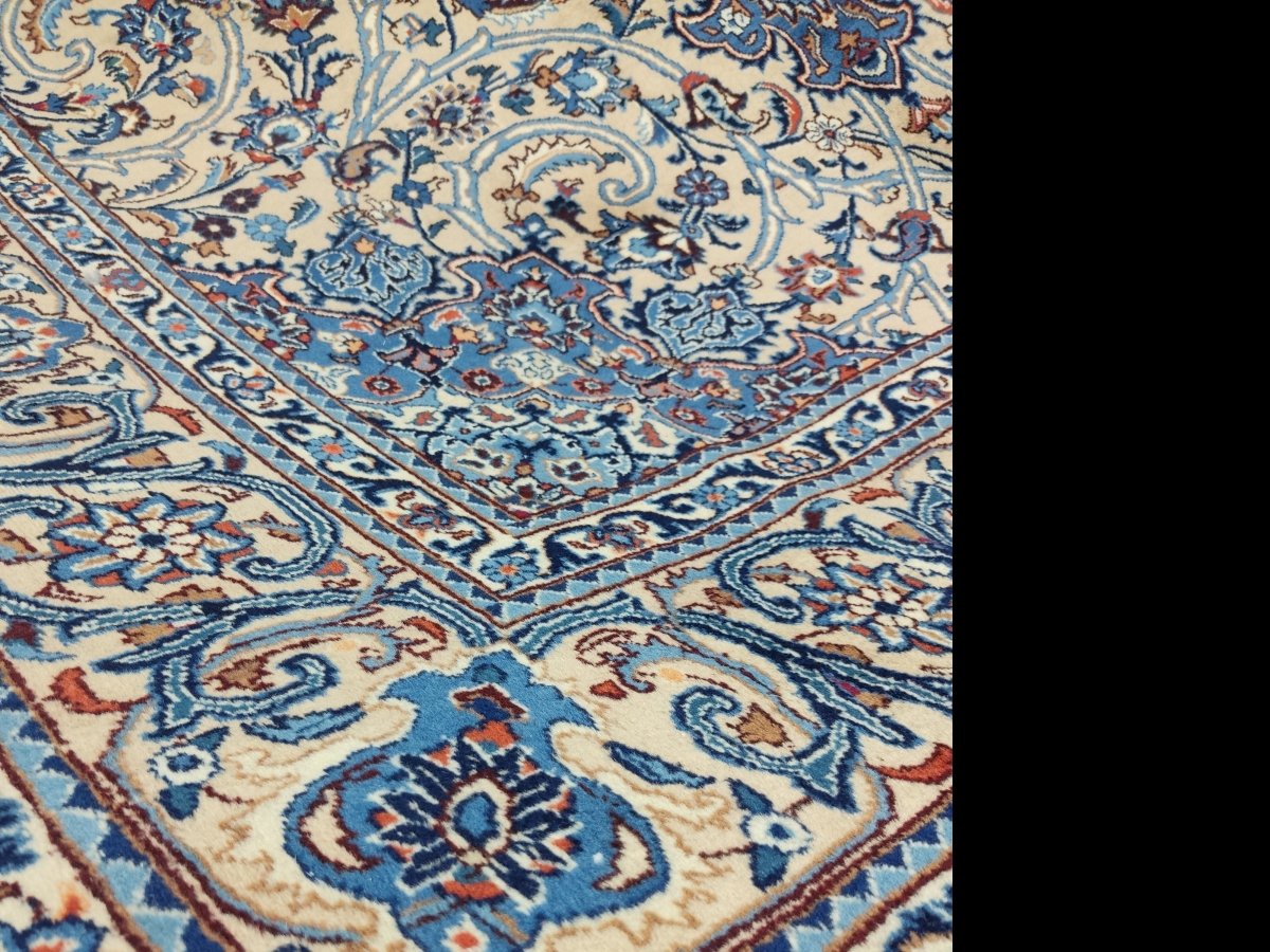 Persian Kashmar rug close-up, blue floral corner border on cream