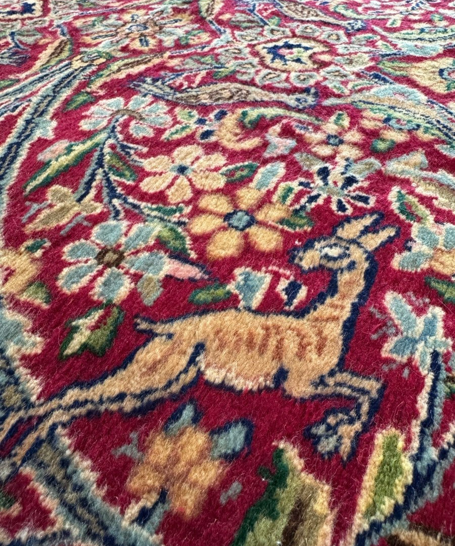 Persian Kerman rug section with red, gold, and teal geometric medallion motifs