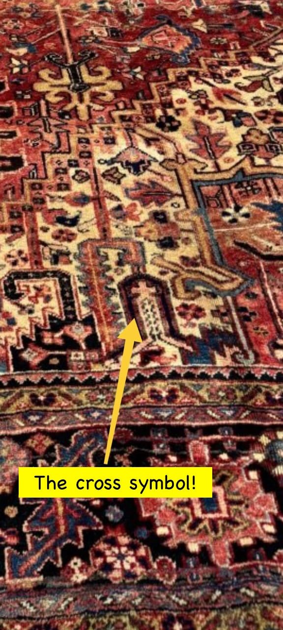 Persian Heriz-style rug close-up showing a cross-like motif on the patterned field