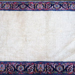 Cream rug field with navy border and repeating blue-red medallion band