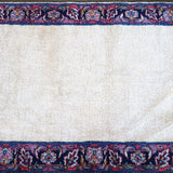 Cream rug field with navy border and repeating blue-red medallion band