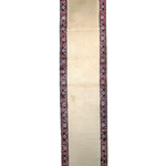 Cream runner rug end view with dark blue border and red ornamental pattern