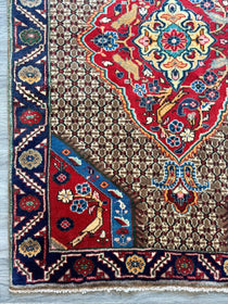 Koliai rug with red, blue, and cream medallion pattern and geometric border.