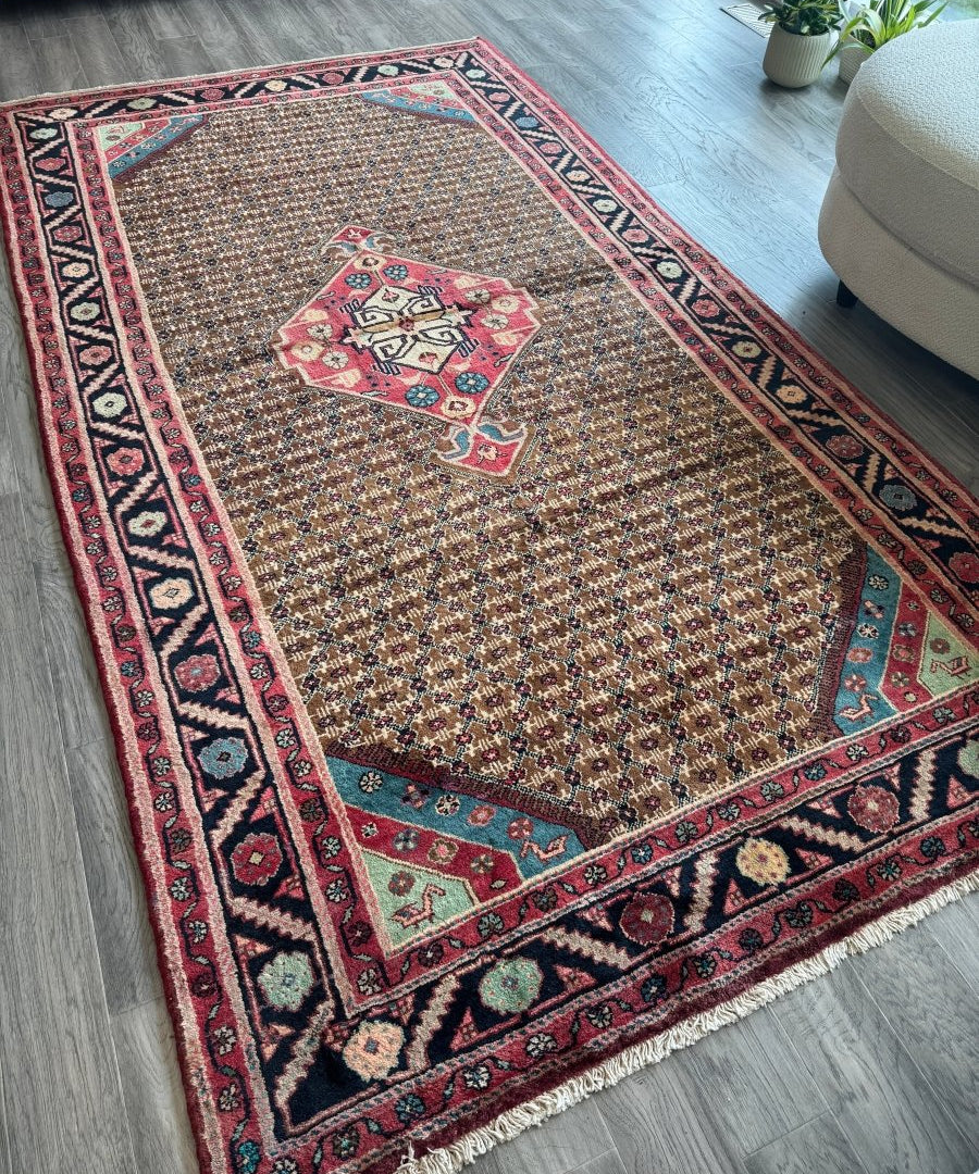 Persian Koliai rug with central red medallion, teal accents, and dark blue border