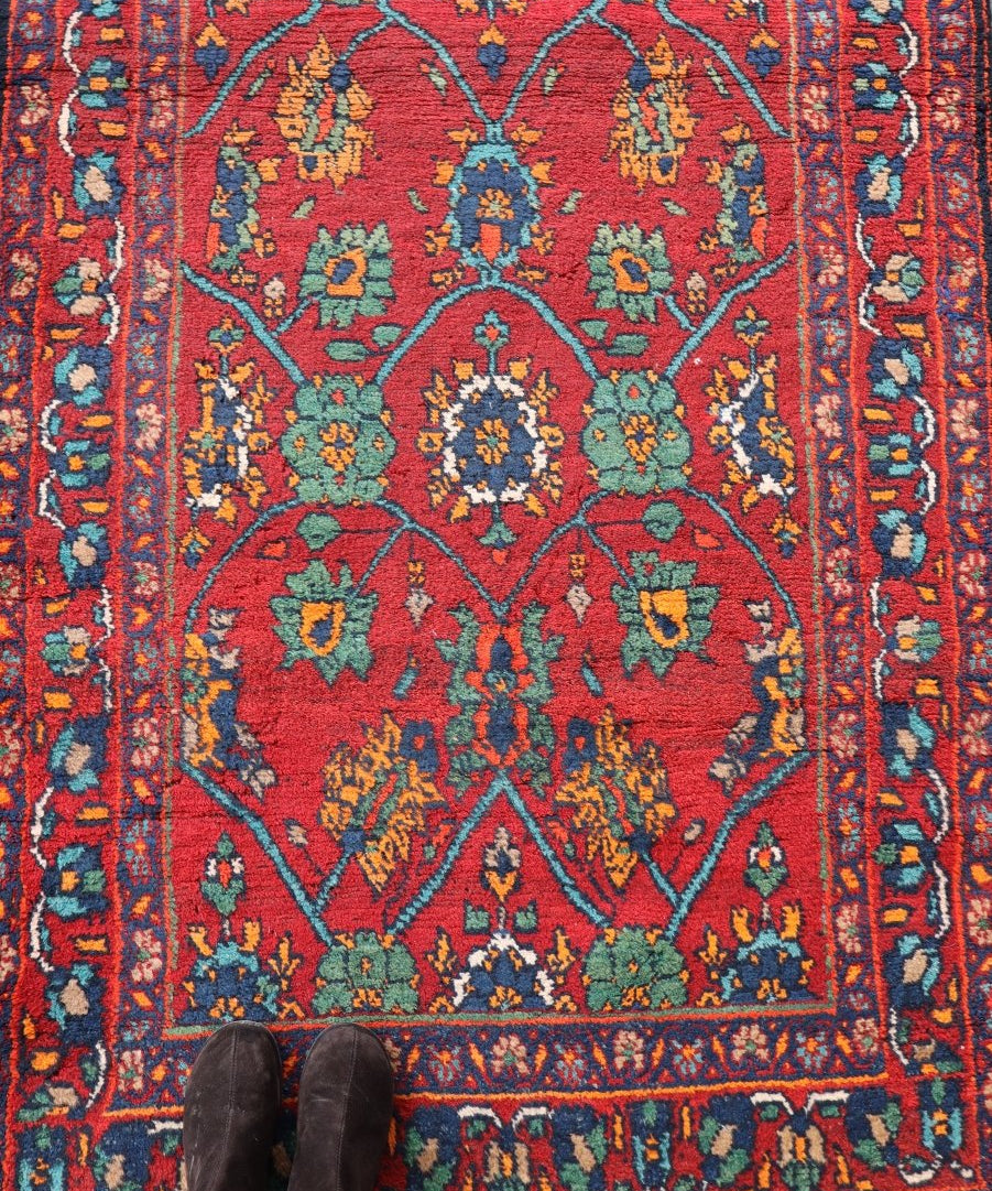 Red runner rug with teal floral medallion pattern and blue ornamental border