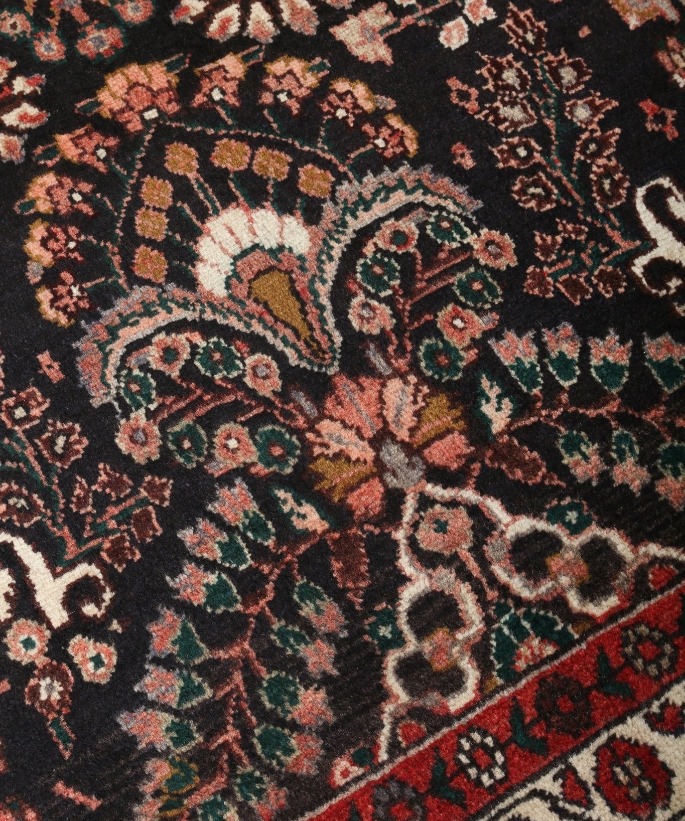 Persian Lilihan runner rug with dark floral medallion pattern and red border