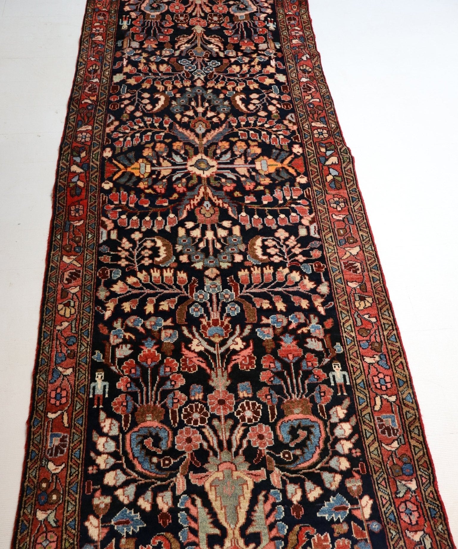 Persian Lilihan runner rug top view with navy field and red vine border