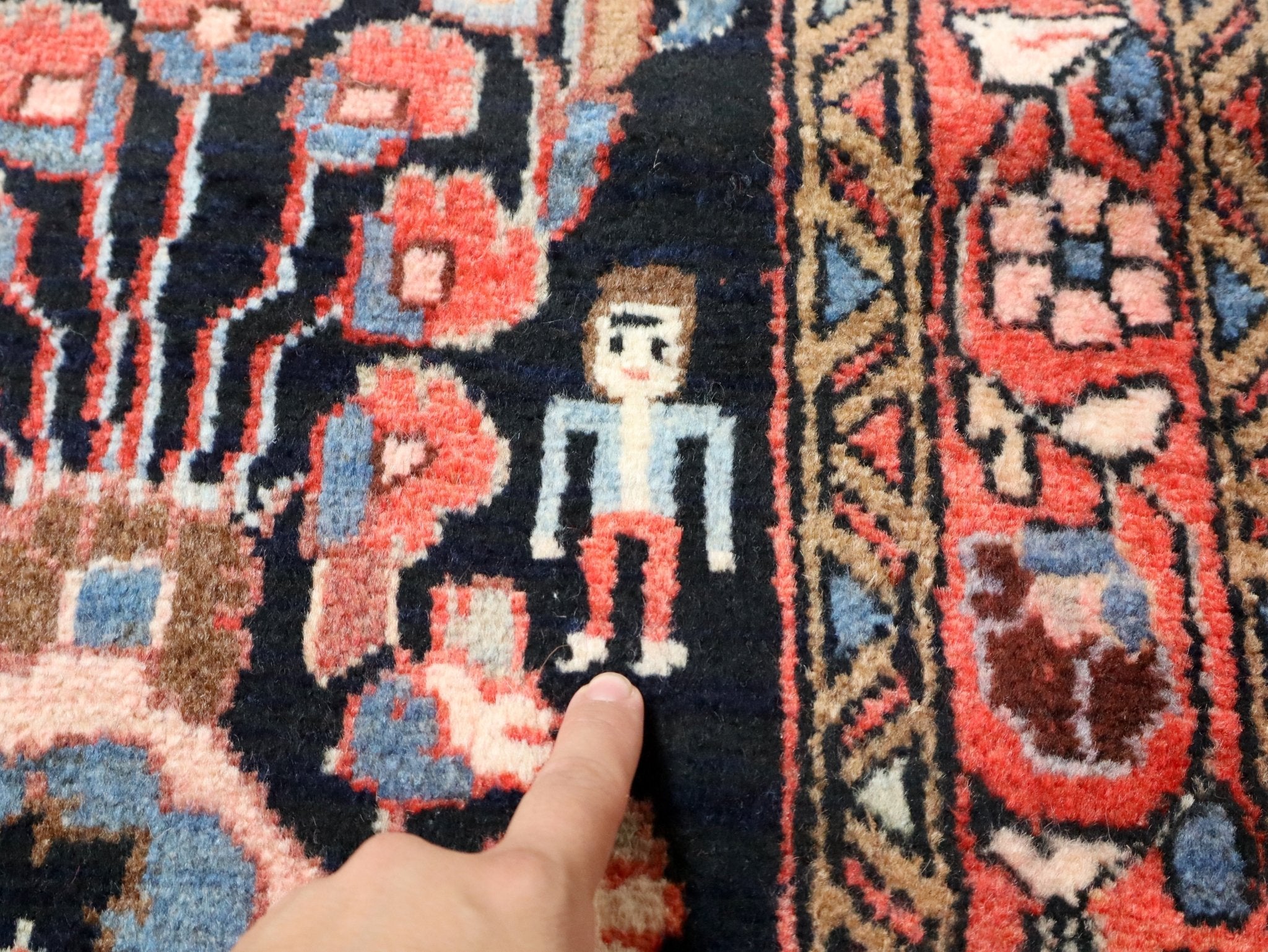 Close-up of Persian Lilihan rug pattern with beige, coral, and blue motifs