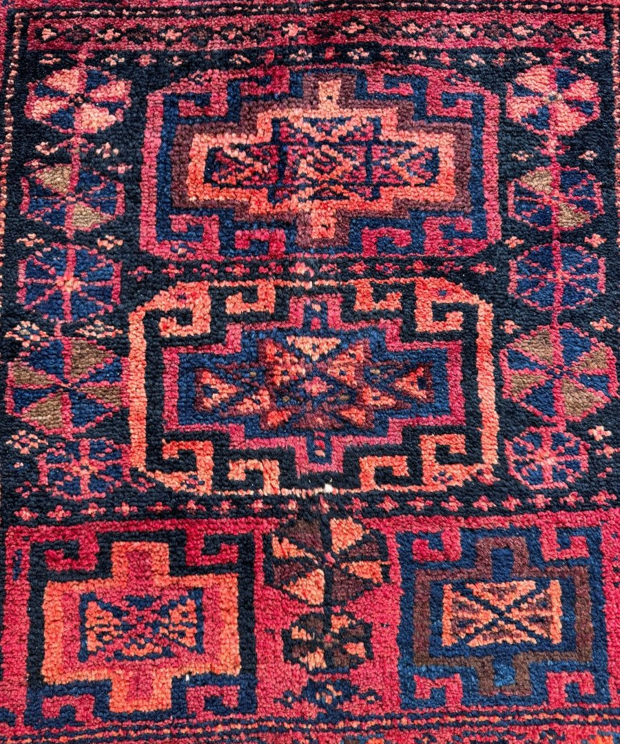 Geometric Lori rug panel in red with navy and light blue repeating motifs