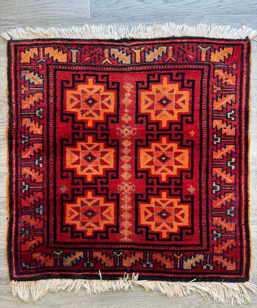 Persian Lori rug, red with navy border, geometric medallions, short fringe edges