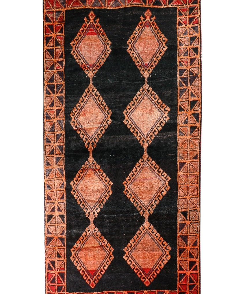 Persian Lori rug with black center and rust geometric diamond medallions