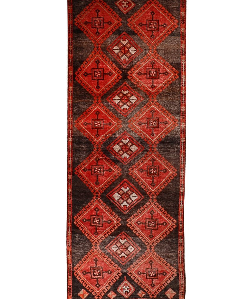 Persian Lori runner rug with dark brown base and red geometric diamond motifs.