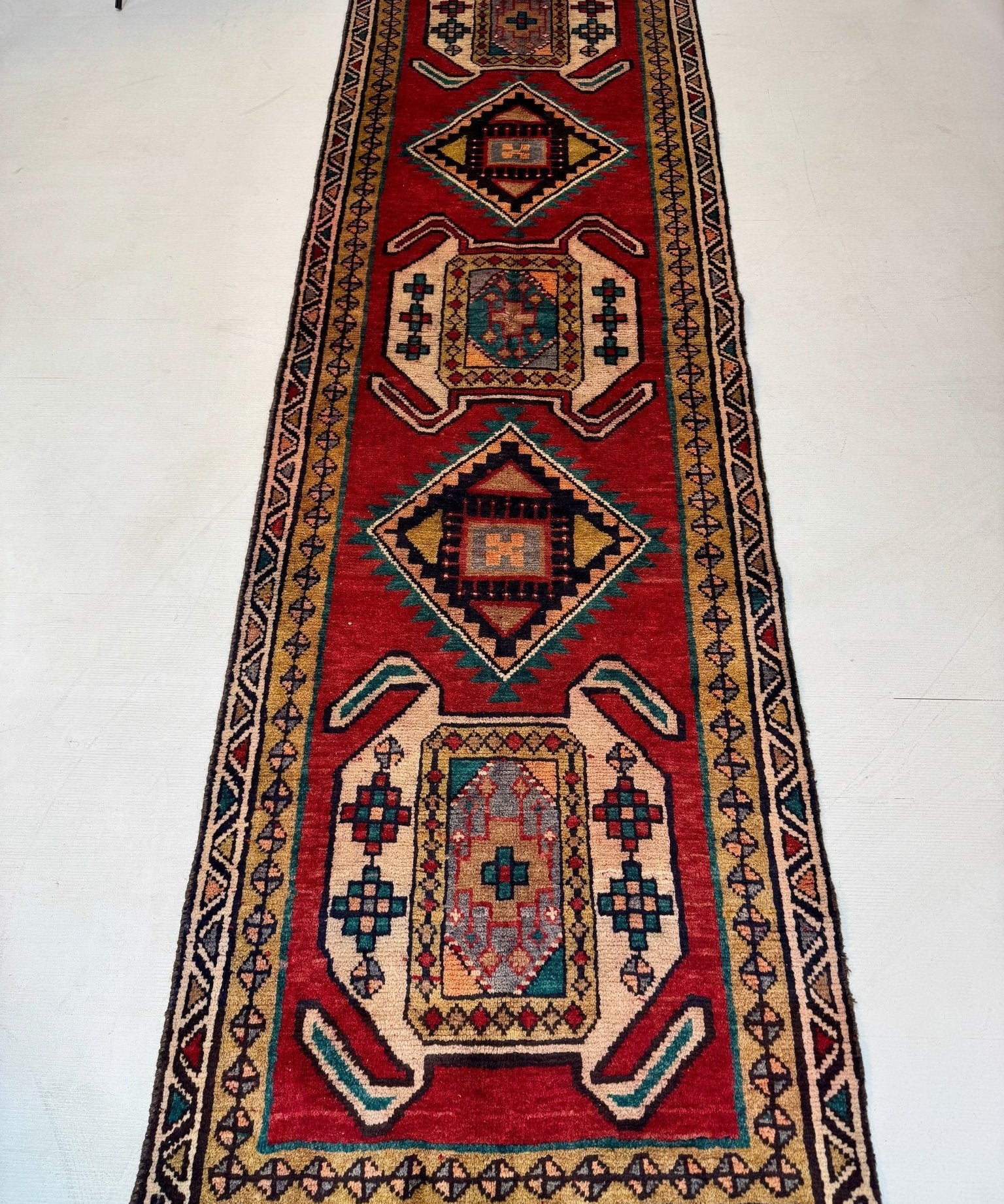 Persian Luri runner rug full view with red center medallions and decorative border