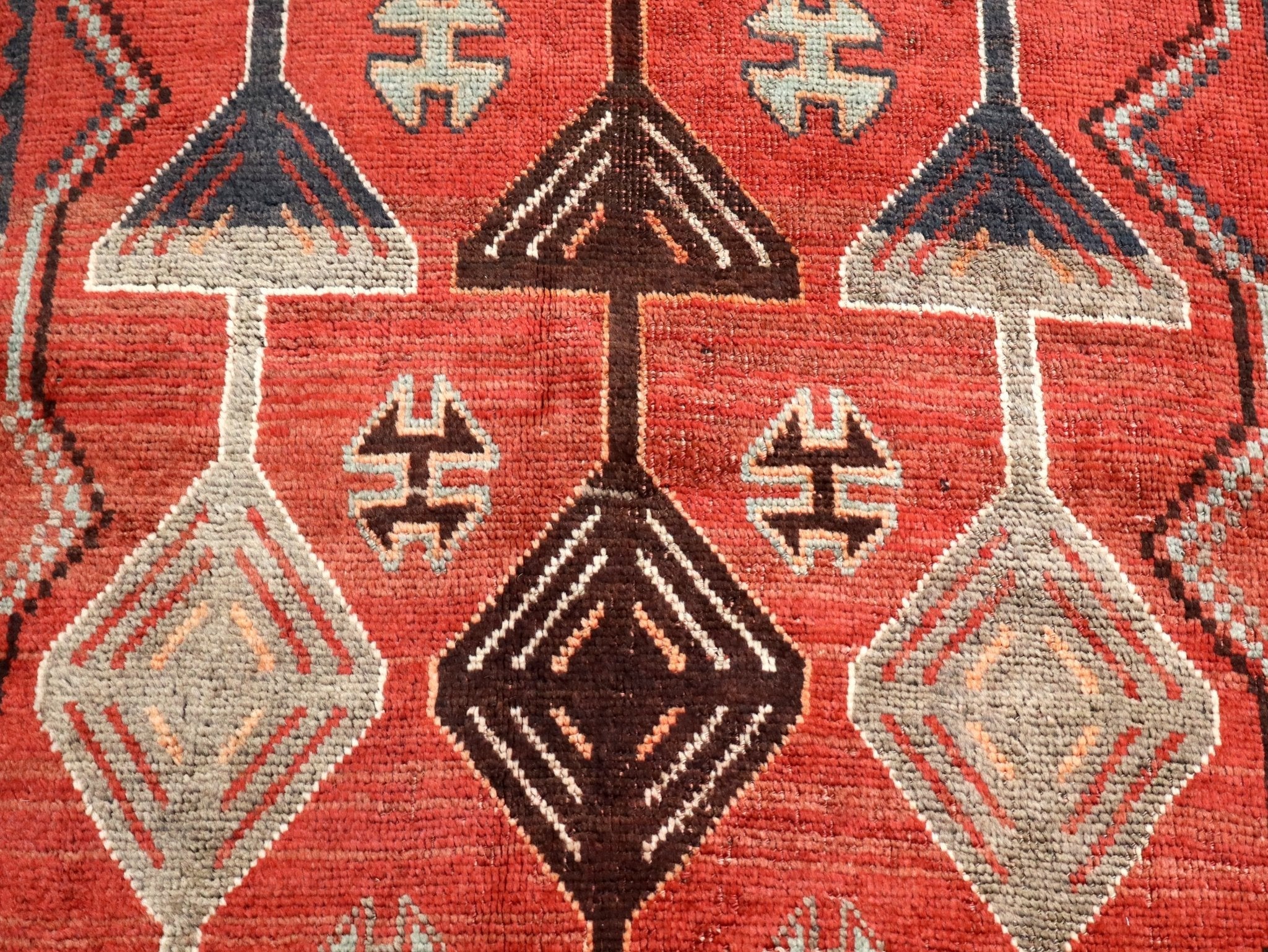 Persian Luri runner rug with red field and white geometric diamond patterns