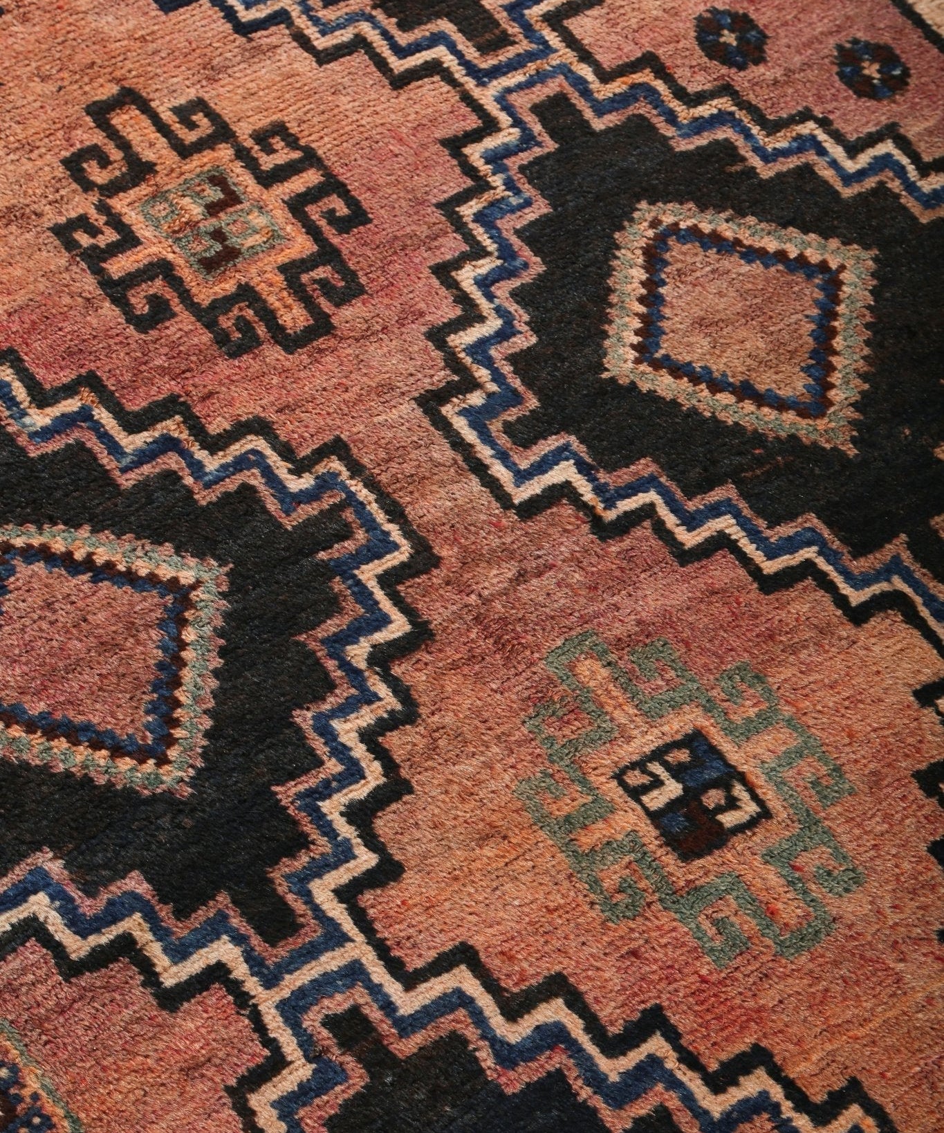 Persian Luri runner rug diagonal view with rust orange zigzag and small geometric motifs