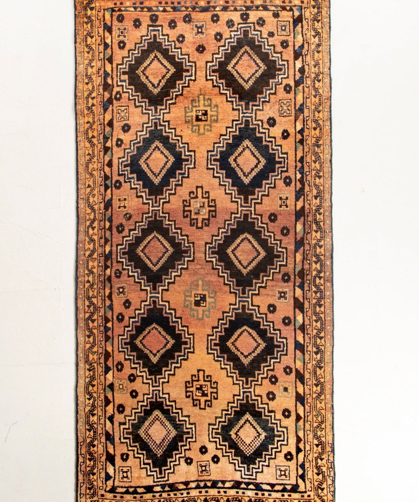 Persian Luri runner rug full view with rust orange diamond medallion pattern and border